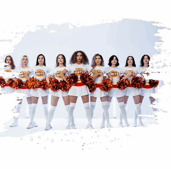Cheerleaders in team uniforms with pom-poms. Cheerleaders holding orange pom-poms in team uniform for sports cheers.